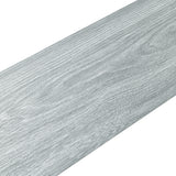 Gray wood-effect PVC flooring tile plank surface with fine realistic wood-grain