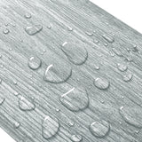 Close-up of gray wood-effect PVC flooring texture with raised wood-grain pattern