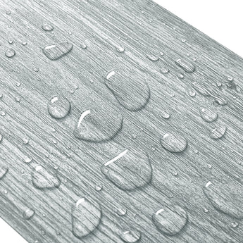 Close-up of gray wood-effect PVC flooring texture with raised wood-grain pattern