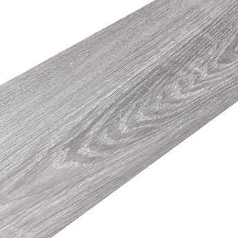 Close-up gray wood-effect PVC flooring plank showing detailed grain and knots