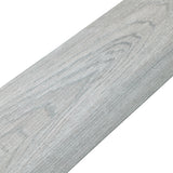 Close-up gray wood-effect PVC flooring plank with smooth wood-grain texture