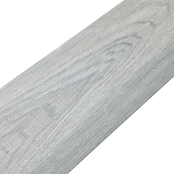 Close-up gray wood-effect PVC flooring plank with smooth wood-grain texture