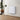 White aluminium panel electric wall heater mounted on wall, ribbed face.