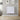 White aluminium panel electric wall heater on wall, ribbed front panels.