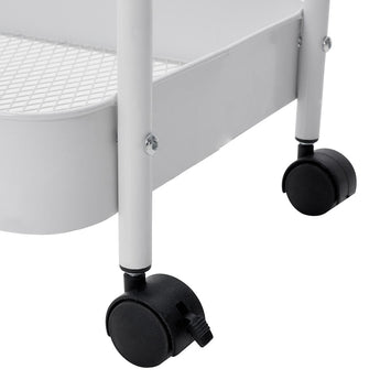 Close-up of black caster wheels under the white rolling clothes rack