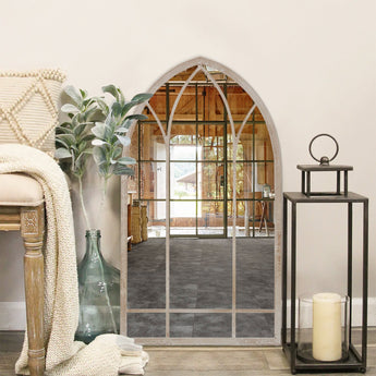 Arched metal garden wall mirror with window-style grid, full front view