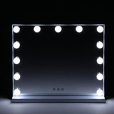 Hollywood makeup mirror with LED bulbs glowing around a dark reflective surface