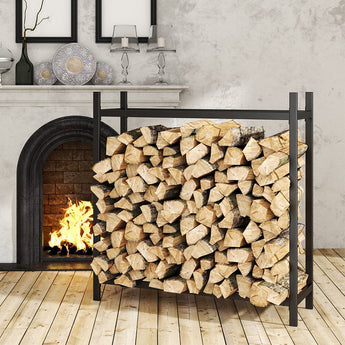Black iron log holder packed with split firewood beside fireplace