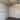 Empty interior of green metal storage shed with corrugated walls and ceiling beams