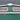Gabled roof gable panel with two front ventilation grilles on green metal shed