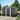 Black steel garden storage shed with gabled roof, double doors, and wall vents