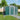 Green metal garden tools shed with gabled roof and double doors, ventilation vents on top
