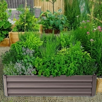 Square raised garden bed planter box with gray metal slats and green plants inside