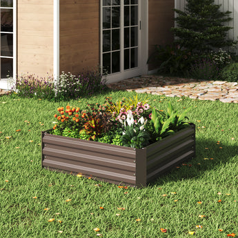 Square raised garden bed planter box with gray metal sides and colorful spring bulbs