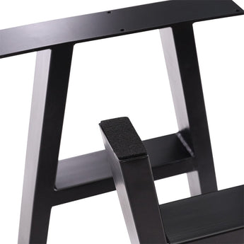 Close-up of black metal table leg end cap and steel support bar