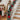 Artificial LED Christmas garland with red poinsettias and warm white lights on railing