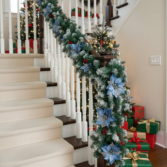 Artificial LED Christmas garland with blue flowers and warm white lights on staircase