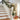 Artificial LED Christmas garland with cream star flowers and warm white lights on railing