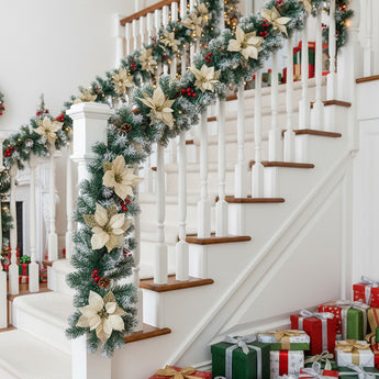 Artificial LED Christmas garland with cream star flowers and warm white lights on stairs