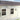 White outdoor rain shelter with clear curved canopies mounted to wall, 2 sections