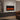 Wall-mounted electric fireplace with black frame and glowing flame display