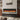60-inch wall electric fireplace with orange flame strip and dark glass frame