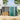 Green and charcoal metal garden storage shed with closed double doors, gable roof.