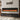 Wall-mounted electric fireplace with black frame, orange flame display in gray surround