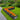 Charcoal black L-shaped raised garden bed with long planting rows and orange flowers