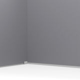 Inside corner of plastic garden storage shed with gray wall panel and white base trim