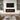 Wall-mounted electric fireplace insert with dark glass front and orange flame LED effect
