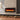 Black glass LED electric fireplace insert, mounted flush in stone wall niche