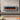 Wall-mounted electric fireplace insert with dark glass front and glowing orange flame LEDs