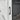 White cabinet door handle beside recessed electric fireplace opening