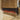 Electric fireplace insert with flame effect in black glass, set in wood-paneled wall