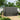 Lockable outdoor bike storage shed with double doors closed and front latch