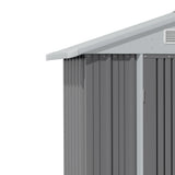 Corner view of metal shed roof overhang and grey corrugated wall panels