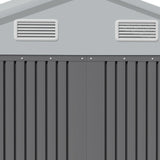 Shed roof vents on white gable panel above grey corrugated wall