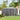 Outdoor tool storage shed with closed double doors and metal side walls
