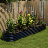 Anthracite oval raised garden bed with layered steel sides, planted with flowers and herbs