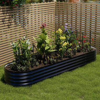 Anthracite oval raised garden bed with layered steel sides, planted with flowers and herbs