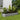 Silver oval raised garden bed with mixed flowers and foliage; 42 cm height