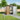 Tawny outdoor storage shed with open double doors and storage shelves inside