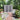 Garden tool and bicycle storage shed with closed double doors and dark gray side panels