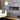 Wall-mounted recessed electric fireplace with black trim and orange flame display
