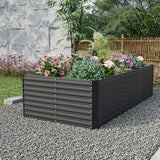 Black rectangular raised garden bed with ribbed steel sides, planted with colorful flowers