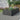 Black rectangular raised garden bed with ribbed steel sides, planted with colorful flowers