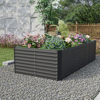 Black rectangular raised garden bed with ribbed steel sides, planted with colorful flowers