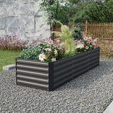 Black raised garden bed with slatted metal panels, filled with mixed flowers and greenery