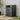 Charcoal black metal trash bin shed with open side door, ridged panels and top handle